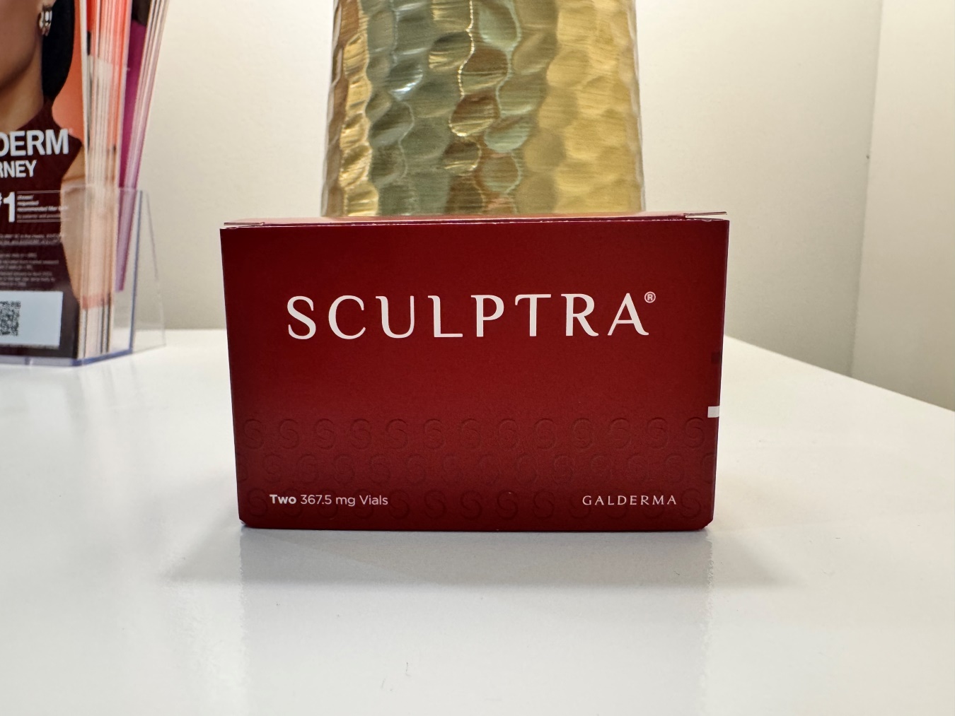 Box labeled SCULPTTRA with two 367.5 mg vials, Galderma brand, red packaging on a white surface.